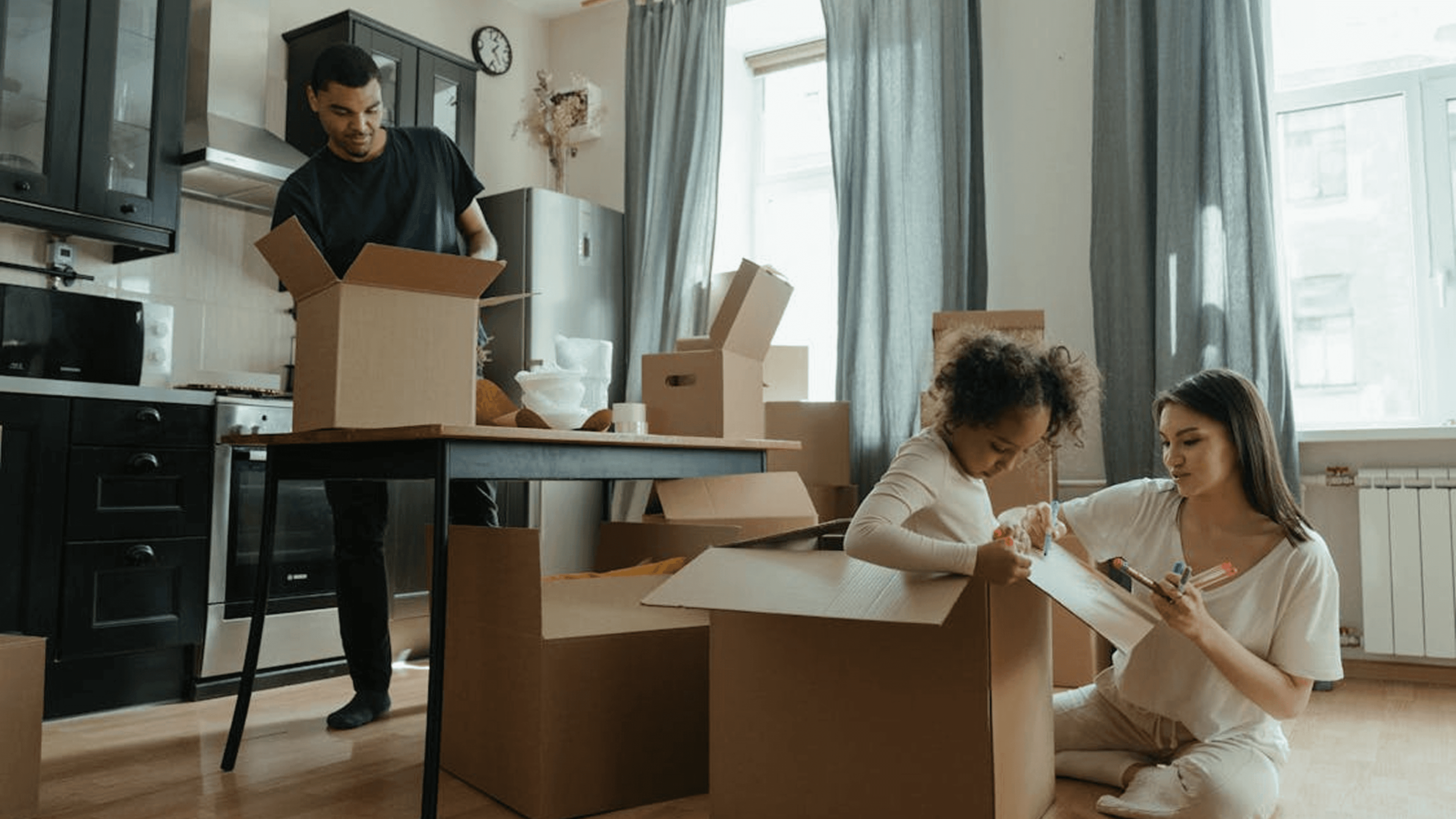 Family packing boxes at home