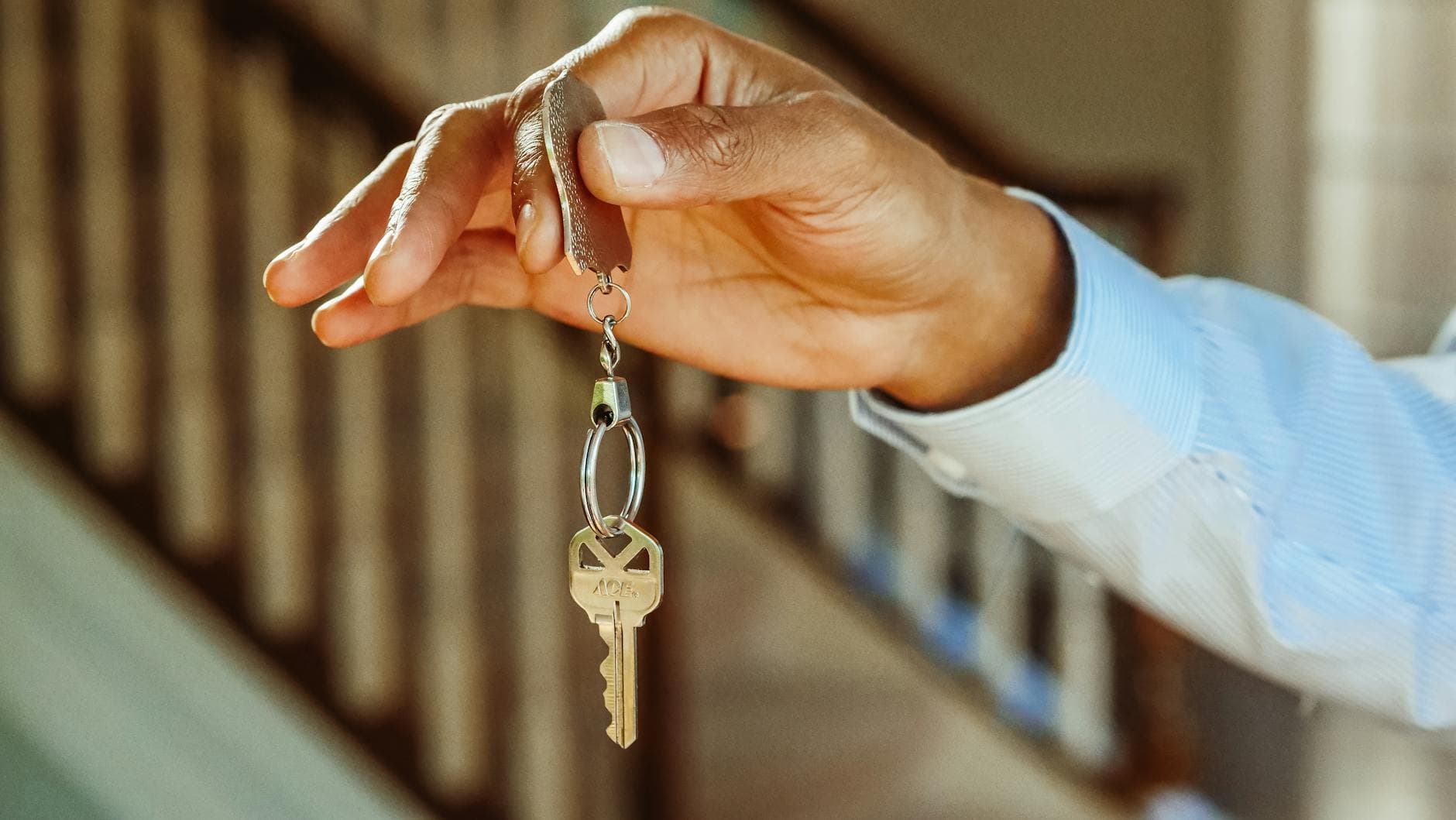 Hand holding keys in a home