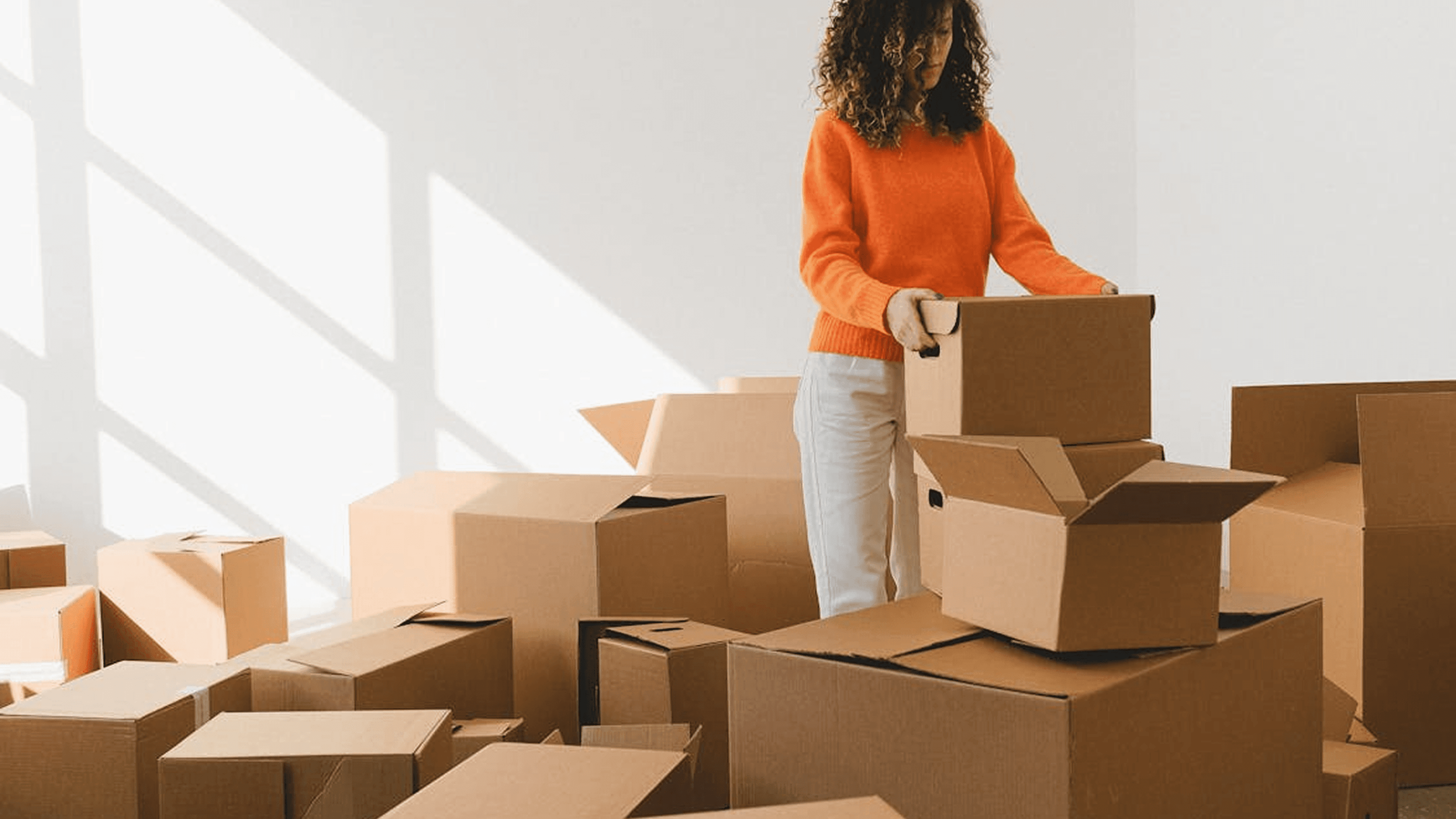 Person packing boxes while preparing to move