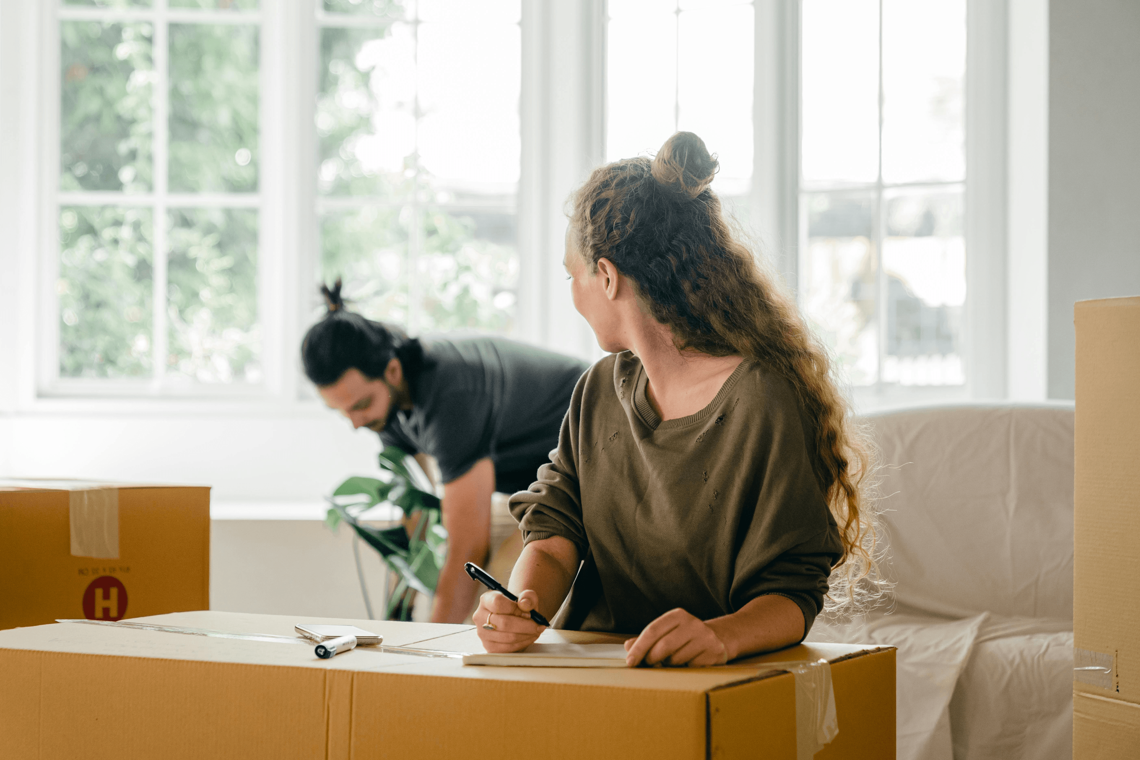 People packing boxes together at home